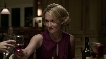 Movie still from “Hellraiser: Revelations” (2011), directed by Víctor Garcia – A woman in a purple dress is holding a wine glass in her right hand; Close Up shot, Over the shoulder angle