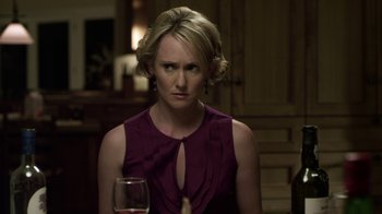 Movie still from “Hellraiser: Revelations” (2011), directed by Víctor Garcia – A woman sitting at a table with a glass of wine in front of her; Close Up shot, Over the shoulder angle