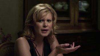 Movie still from “Hellraiser: Revelations” (2011), directed by Víctor Garcia – A blonde woman is sitting in front of a window; Close Up shot, Over the shoulder angle