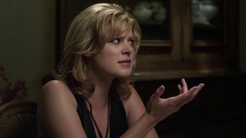 Movie still from “Hellraiser: Revelations” (2011), directed by Víctor Garcia – A beautiful blonde woman sitting in front of a window; Close Up shot, Over the shoulder angle