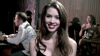 Movie still from “Hellraiser: Revelations” (2011), directed by Víctor Garcia – A beautiful young lady smiling for the camera; Close Up shot, Over the shoulder angle