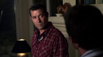 Movie still from “Hellraiser: Revelations” (2011), directed by Víctor Garcia – A person wearing a plaid shirt; Close Up shot, Over the shoulder angle