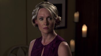 Movie still from “Hellraiser: Revelations” (2011), directed by Víctor Garcia – A woman in a purple dress is looking at the camera; Close Up shot, Over the shoulder angle