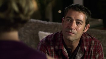 Movie still from “Hellraiser: Revelations” (2011), directed by Víctor Garcia – A person sitting on a couch; Close Up shot, Over the shoulder angle