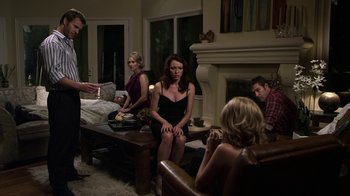 Movie still from “Hellraiser: Revelations” (2011), directed by Víctor Garcia – A group of people sitting around a living room; Wide shot, Over the shoulder angle