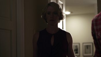 Movie still from “Hellraiser: Revelations” (2011), directed by Víctor Garcia – A woman standing in a room in the dark; Medium shot, Over the shoulder angle