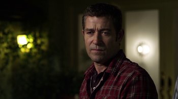 Movie still from “Hellraiser: Revelations” (2011), directed by Víctor Garcia – A person wearing a plaid shirt; Close Up shot, Over the shoulder angle