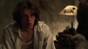 Movie still from “Hellraiser: Revelations” (2011), directed by Víctor Garcia – A young man with long hair and a white striped shirt; Close Up shot, Over the shoulder angle