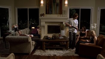 Movie still from “Hellraiser: Revelations” (2011), directed by Víctor Garcia – A group of people in a living room with a fire place; Wide shot, Over the shoulder angle