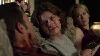 Movie still from “Hellraiser: Revelations” (2011), directed by Víctor Garcia – A woman with a cut face sitting on a couch; Close Up shot, Over the shoulder angle