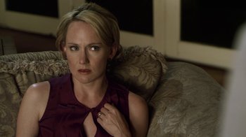 Movie still from “Hellraiser: Revelations” (2011), directed by Víctor Garcia – A woman sitting on top of a couch in a living room; Close Up shot, Over the shoulder angle