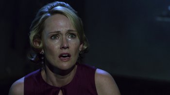 Movie still from “Hellraiser: Revelations” (2011), directed by Víctor Garcia – A person with a crying expression on their face; Close Up shot, Over the shoulder angle