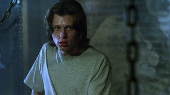 Movie still from “Hellraiser: Revelations” (2011), directed by Víctor Garcia – A man with long hair is looking at the camera; Close Up shot, Low angle