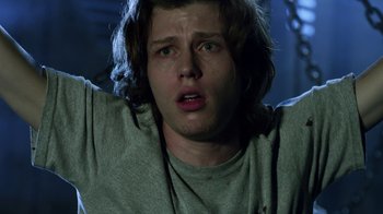 Movie still from “Hellraiser: Revelations” (2011), directed by Víctor Garcia – A young man with long hair and a gray shirt; Close Up shot, Low angle