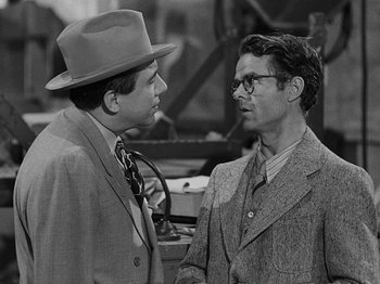 Movie still from “Hellzapoppin'” (1941), directed by H.C. Potter – Two men talking to each other while wearing hats; Close Up shot, Over the shoulder angle