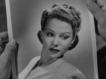 Movie still from “Hellzapoppin'” (1941), directed by H.C. Potter – An old photo of an older woman with big hair; Close Up shot, Low angle