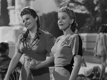 Movie still from “Hellzapoppin'” (1941), directed by H.C. Potter – A couple of women standing next to each other; Medium shot, Low angle