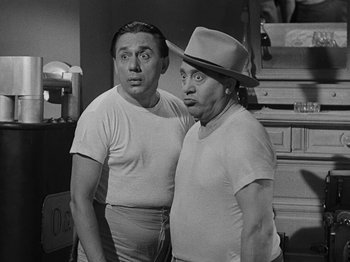 Movie still from “Hellzapoppin'” (1941), directed by H.C. Potter – A couple of men standing next to each other in a kitchen; Medium shot, Low angle