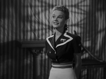 Movie still from “Hellzapoppin'” (1941), directed by H.C. Potter – A black and white photo of a woman smiling; Medium shot, Low angle