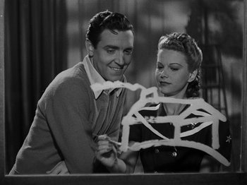 Movie still from “Hellzapoppin'” (1941), directed by H.C. Potter – A man and a woman looking at a piece of paper; Medium shot, Low angle