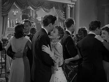Movie still from “Hellzapoppin'” (1941), directed by H.C. Potter – A man and a woman kissing in front of a crowd; Medium shot, Low angle