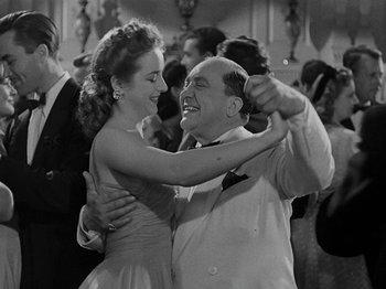 Movie still from “Hellzapoppin'” (1941), directed by H.C. Potter – An older man and a young woman dancing at a party; Medium shot, Low angle
