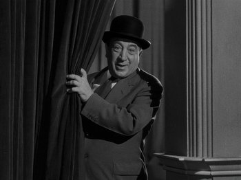 Movie still from “Hellzapoppin'” (1941), directed by H.C. Potter – An older man wearing a suit and a top hat; Medium shot, Low angle