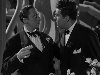 Movie still from “Hellzapoppin'” (1941), directed by H.C. Potter – Two men in tuxedos talking to each other; Medium shot, Over the shoulder angle