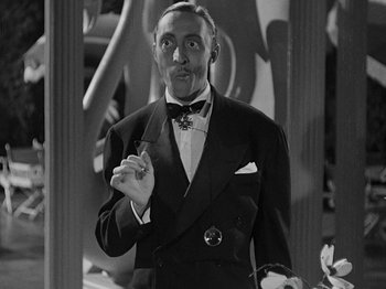 Movie still from “Hellzapoppin'” (1941), directed by H.C. Potter – A man in a suit and tie holding a cigarette; Close Up shot, Low angle
