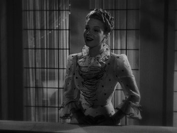 Movie still from “Hellzapoppin'” (1941), directed by H.C. Potter – A black and white photo of a woman in a costume; Medium shot, Low angle