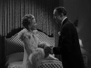 Movie still from “Hellzapoppin'” (1941), directed by H.C. Potter – A man and a woman holding hands in a room; Medium shot, High angle