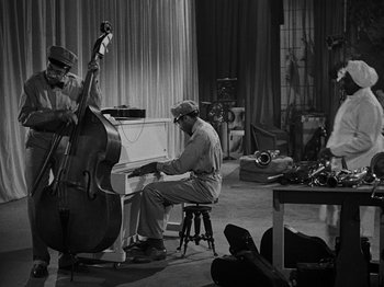 Movie still from “Hellzapoppin'” (1941), directed by H.C. Potter – A man sitting at a piano in front of another man playing a double bass; Wide shot, High angle