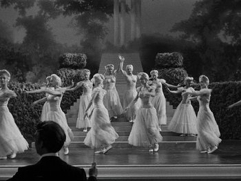 Movie still from “Hellzapoppin'” (1941), directed by H.C. Potter – A black and white photo of a group of women dancing on a stage; Wide shot, High angle