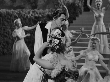 Movie still from “Hellzapoppin'” (1941), directed by H.C. Potter – A man and a woman dance in front of a group of people; Medium shot, Low angle