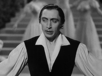 Movie still from “Hellzapoppin'” (1941), directed by H.C. Potter – A black - and - white photo of a man with his eyes closed; Close Up shot, Over the shoulder angle