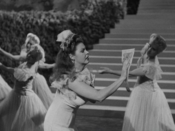 Movie still from “Hellzapoppin'” (1941), directed by H.C. Potter – A group of young women dressed in vintage clothing; Medium shot, High angle