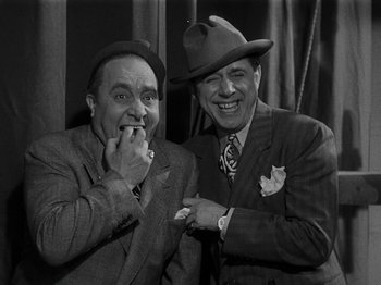 Movie still from “Hellzapoppin'” (1941), directed by H.C. Potter – A couple of men standing next to each other; Medium shot, High angle