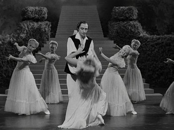 Movie still from “Hellzapoppin'” (1941), directed by H.C. Potter – A man and a woman dancing in front of a group of women; Wide shot, High angle