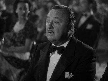 Movie still from “Hellzapoppin'” (1941), directed by H.C. Potter – An older man wearing a tuxedo in front of an audience; Close Up shot, Low angle
