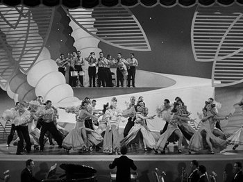 Movie still from “Hellzapoppin'” (1941), directed by H.C. Potter – A black and white photo of a group of people on a stage; Extreme Wide shot, High angle