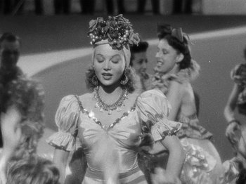 Movie still from “Hellzapoppin'” (1941), directed by H.C. Potter – A black - and - white photo of a woman in a dress; Medium shot, Low angle