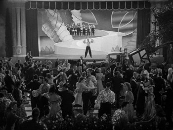 Movie still from “Hellzapoppin'” (1941), directed by H.C. Potter – A crowd of people standing in front of a stage; Extreme Wide shot, High angle