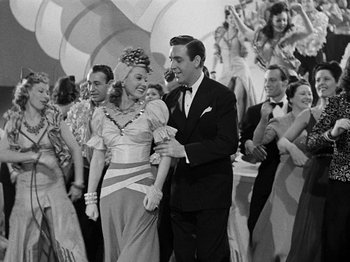 Movie still from “Hellzapoppin'” (1941), directed by H.C. Potter – A man and a woman are dancing in front of a crowd; Medium shot, Low angle