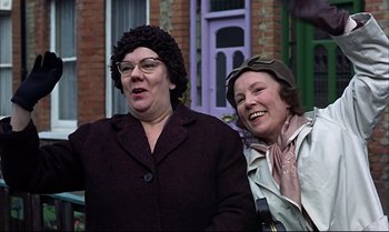 Movie still from “Help!” (1965), directed by Richard Lester – Two older women standing next to each other outside; Close Up shot, Low angle