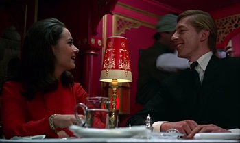 Movie still from “Help!” (1965), directed by Richard Lester – A man and a woman sitting at a dinner table; Medium shot, Low angle