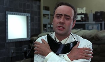 Movie still from “Help!” (1965), directed by Richard Lester – A man wearing a neck tie and a white dress shirt; Close Up shot, Low angle