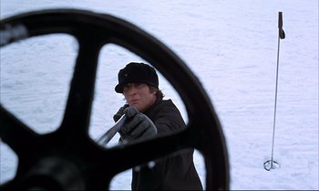 Movie still from “Help!” (1965), directed by Richard Lester – A man in a black jacket and a black hat is looking at himself in a mirror; Close Up shot, Low angle