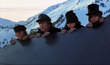 Movie still from “Help!” (1965), directed by Richard Lester – A group of young people climbing on a wall; Medium shot, Low angle