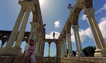Movie still from “Help!” (1965), directed by Richard Lester – A group of people standing on top of an old building; Extreme Wide shot, Low angle