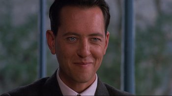 Movie still from “Henry & June” (1990), directed by Philip Kaufman – A person wearing a suit and tie; Close Up shot, Over the shoulder angle